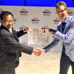 Representatives of the ACT Alliance and Pusbinlat Motivator shaking hands