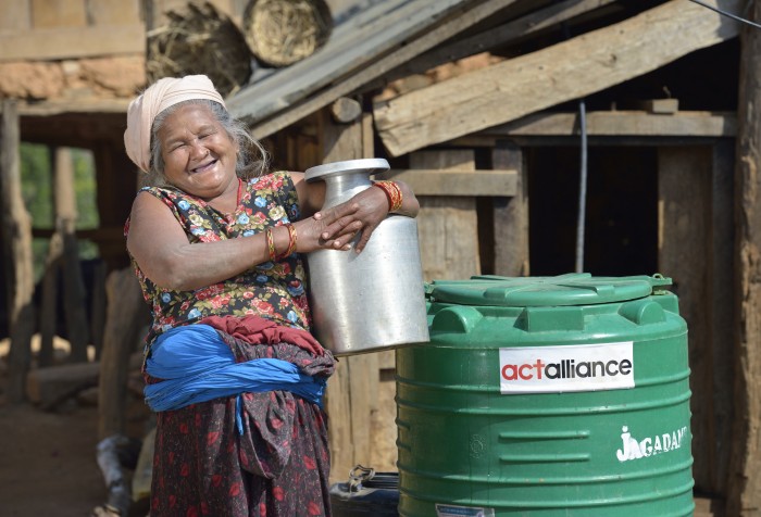 Tika Maya Pulami holds a water pot as she fetches water from a cistern in Salang, a village in the Dhading District of Nepal where Dan Church Aid, a member of the ACT Alliance, has provided a variety of support to local villagers in the wake of a devastating 2015 earthquake. The village's water system was destroyed by the quake, forcing women to walk two hours or more to a nearby river to fetch water. Working with a local organization, the Forum for Awareness and Youth Activity, the ACT Alliance rebuilt the village's water system.