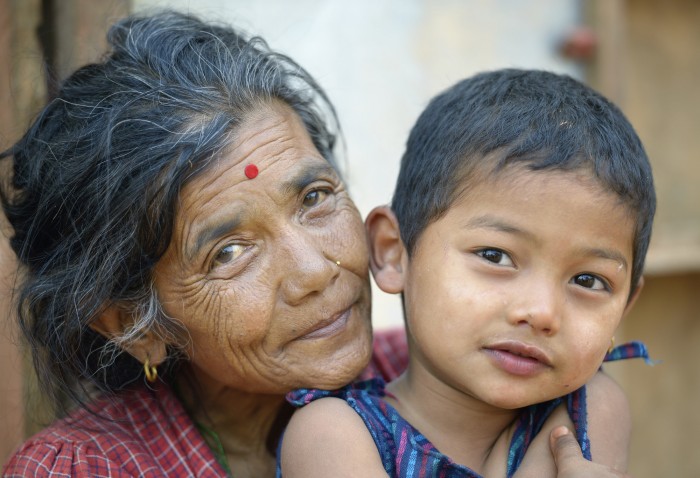 Hari Maya Bhujel hugs her grandson, 5-year old Utsab, in Majhitar, a village in the Dhading District of Nepal where Dan Church Aid, a member of the ACT Alliance, has provided a variety of support to local villagers in the wake of a devastating 2015 earthquake. Parental consent obtained. Photo: Paul Jeffrey