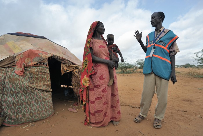 Mohammed Haibe (right) is a Community Peace and Security Team member in the Ifo Camp, part of the Dadaab refugee complex in northeastern Kenya. here he talks with Faduma Absher Tuko. The CPSTs, coordinated by the ACT Alliance, provide self-policing in the camps. They team members are all refugees and volunteers. The Lutheran World Federation, a member of the ACT Alliance, is camp manager for the Dadaab complex, essentially the world's largest refugee camp. Photo: Paul Jeffrey