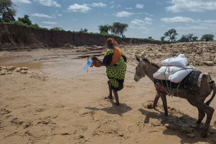 A woman cross the flooded valley with food aid. Gerbile village is hit by drought. And now flooding. The dry soil is not able to absorb the rain, and the flooding destroy the landscape in Fafan zone, Somali region