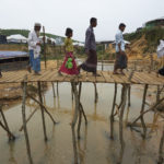 Rohingya refugees crossing bridge