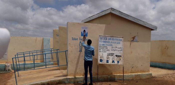 FCA community mobilizer distributes materials on the prevention of COVID19. Photo: Mohamed Ibrahim/FCA Somalia