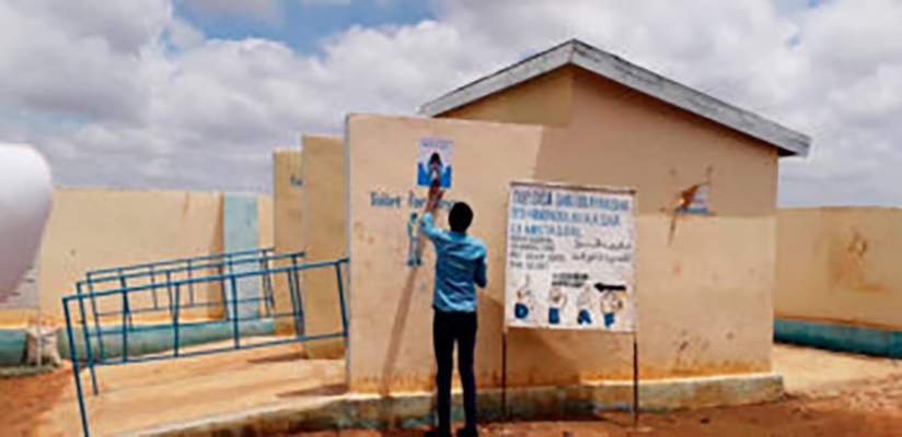 FCA community mobilizer distributes materials on the prevention of COVID19. Photo: Mohamed Ibrahim/FCA Somalia