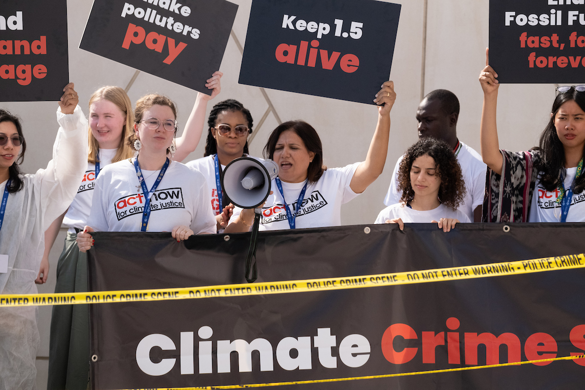 ACT members calling for climate justice during a media action at COP28.